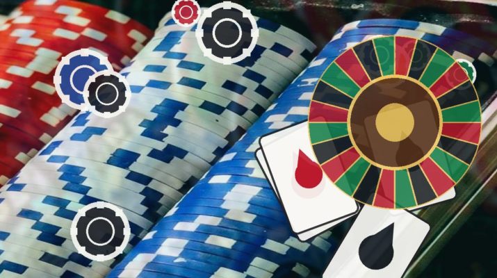 Colorful casino scene with stacked poker chips, a roulette wheel, and two playing cards on a table.